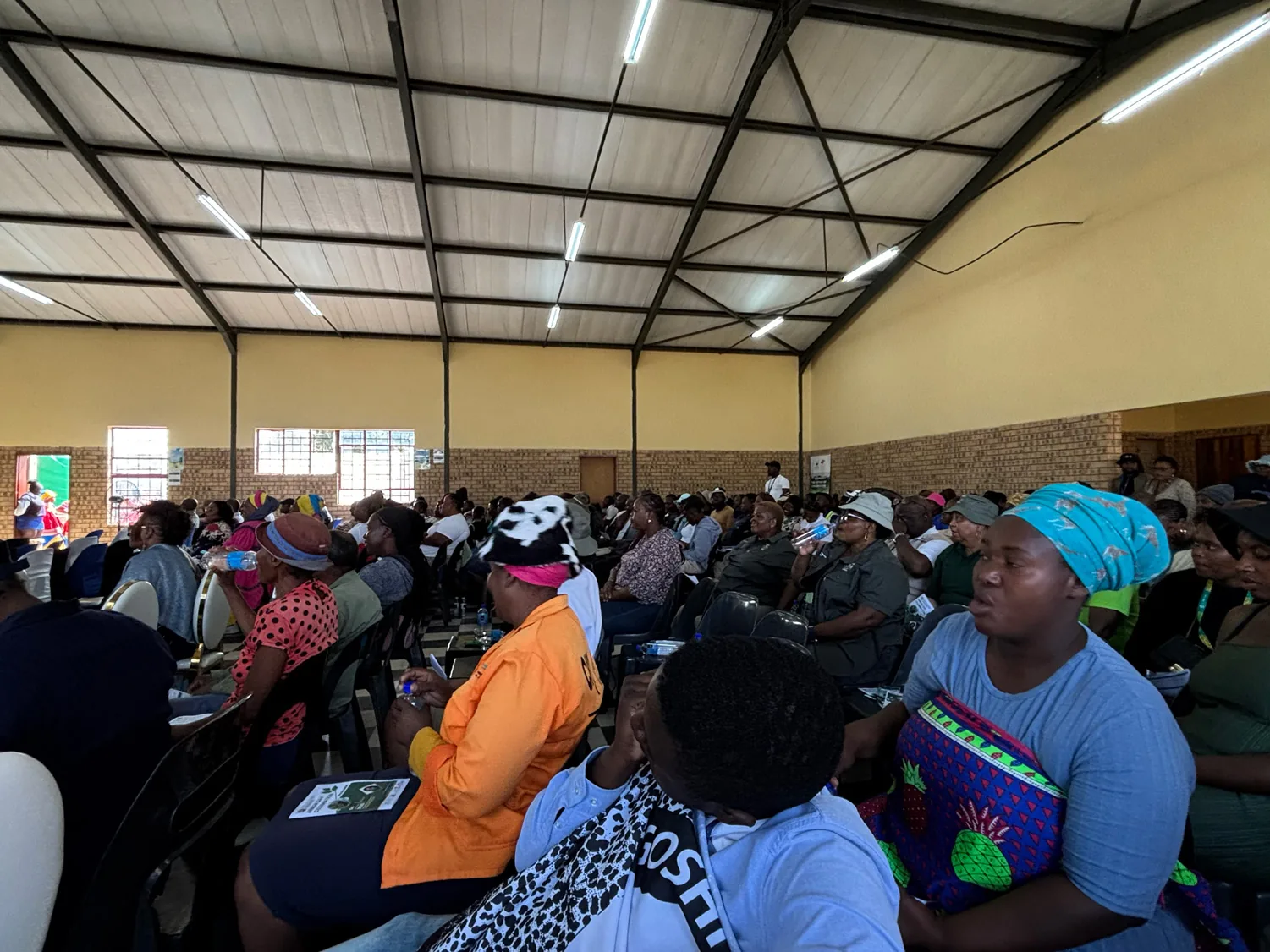 Community meeting with Traditional Authorities in a packed community hall — the relational groundwork that precedes every carbon hectare