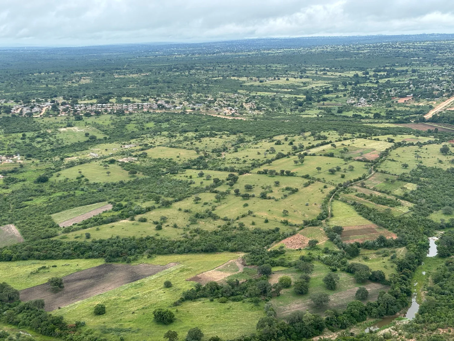 Wide aerial of the catchment mosaic — 630,000 hectares across savanna, grassland, and forest.